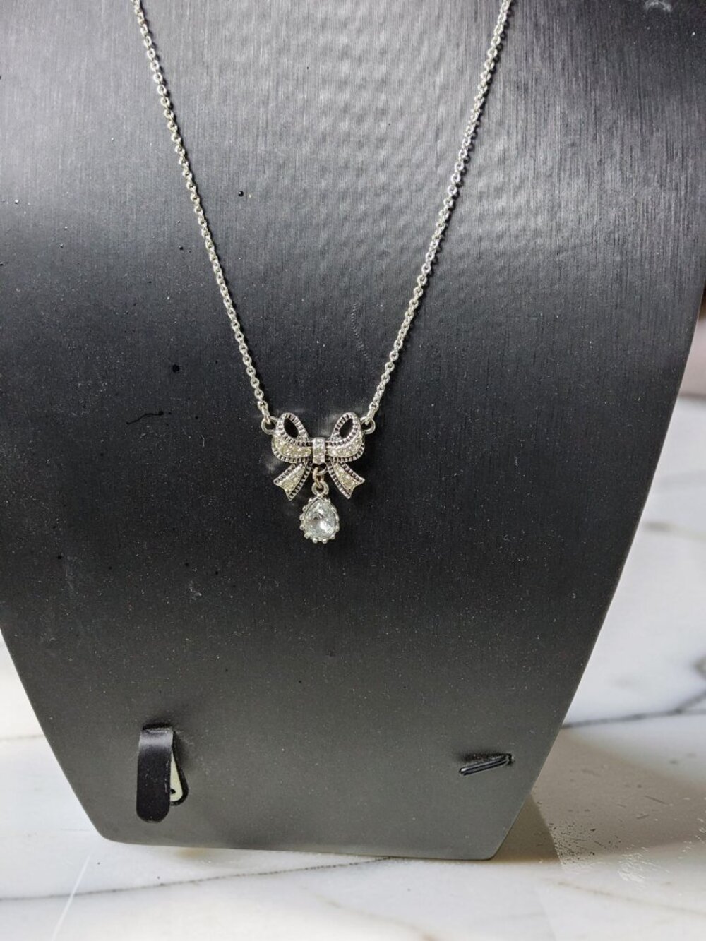 Vintage 1980s NRT Avon Silver Tone Chrystal Lined Bow Pendant